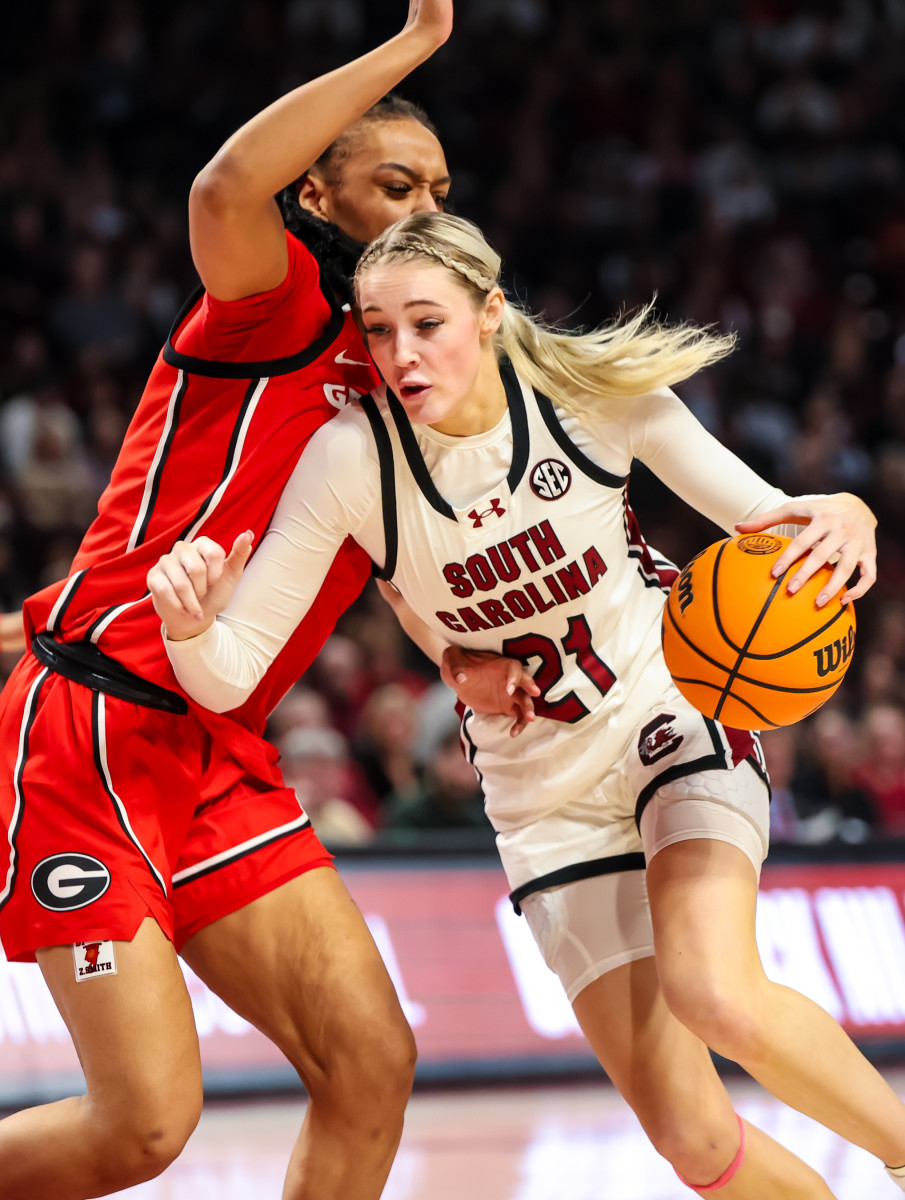 Chloe uses her right arm to shield the basketball from a Georgia defender on a drive to the basket (18th Feb., 2024)