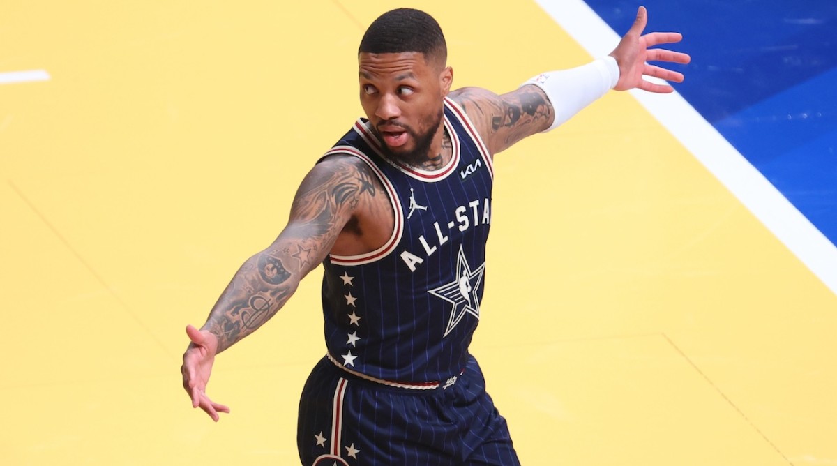 Eastern Conference guard Damian Lillard of the Milwaukee Bucks reacts after making a three-point basket from half court against the Western Conference All-Stars during the third quarter in the 73rd NBA All-Star Game at Gainbridge Fieldhouse in Indianapolis on Feb. 18, 2024.