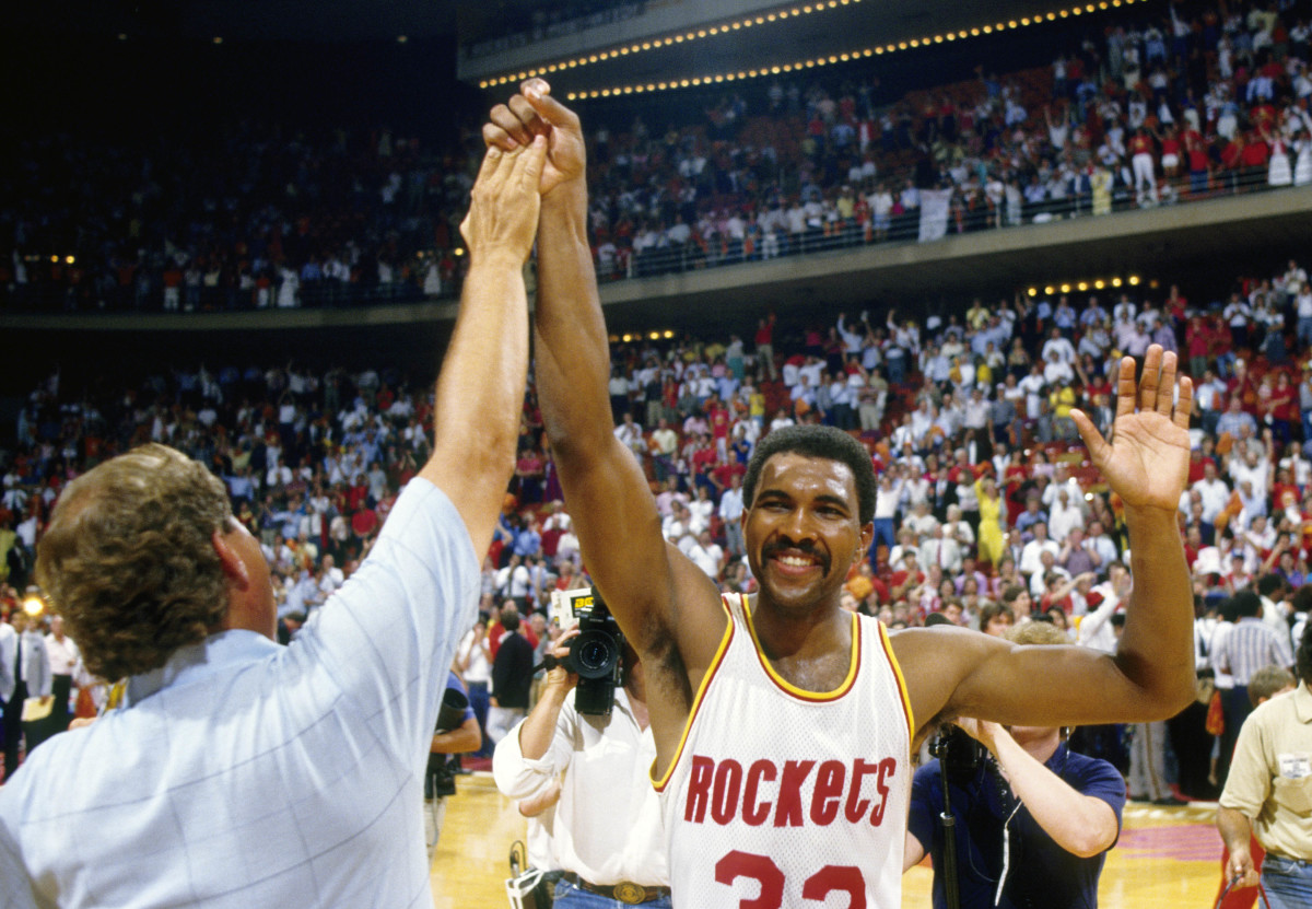 Houston Rockets forward Robert Reid (33) high fives a fan against the Boston Celtics in the 1986 NBA Finals at the Summit.