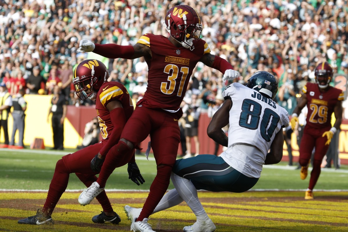Oct 29, 2023; Landover, Maryland, USA; Philadelphia Eagles wide receiver Julio Jones (80) catches a touchdown pass as Washington Commanders safety Kamren Curl (31) defends during the fourth quarter at FedExField.