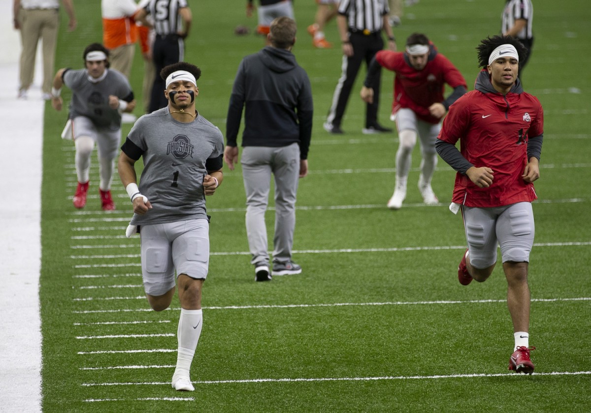 Jan 1, 2021; New Orleans, LA, USA; Ohio State Buckeyes quarterback Justin Fields (1) and quarterback C.J. Stroud (14) warm up prior to the College Football Playoff semifinal against the Clemson Tigers at the Allstate Sugar Bowl in the Mercedes-Benz Superdome in New Orleans on Friday, Jan. 1, 2021.
