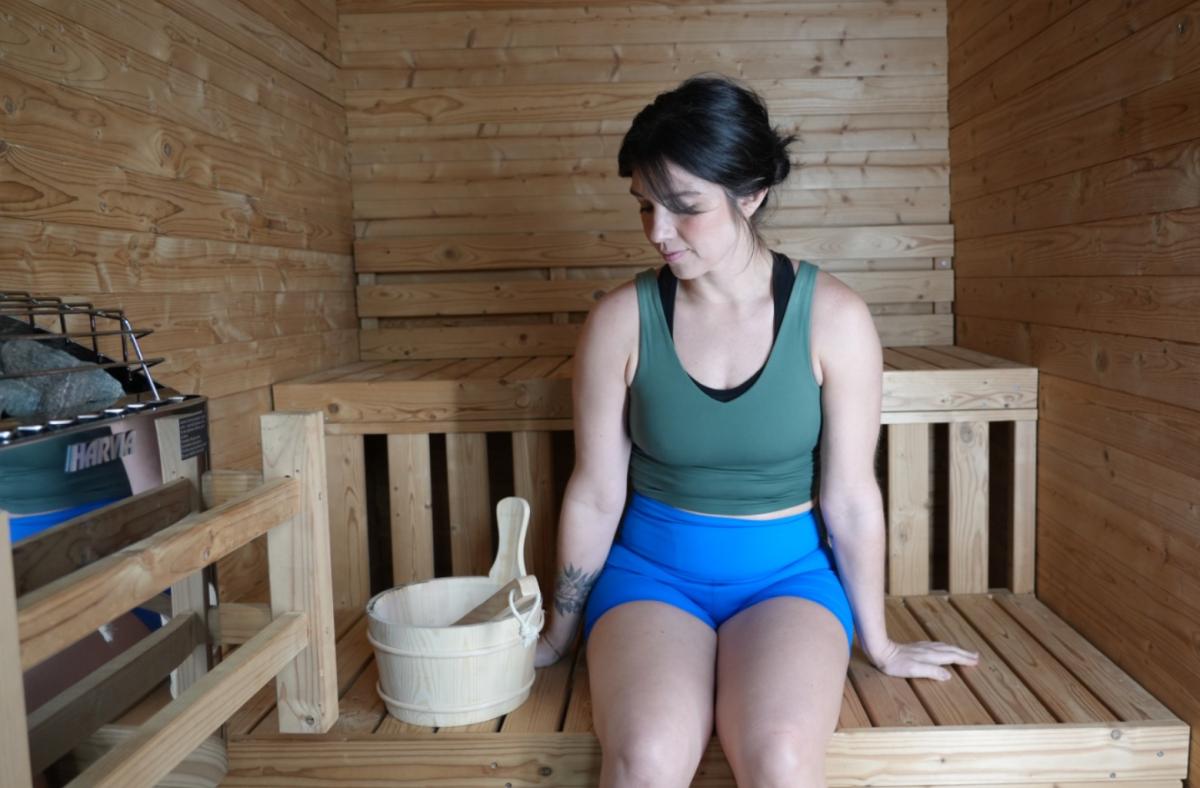 Our tester sits inside of a Redwood Outdoors Thermowood cabin sauna
