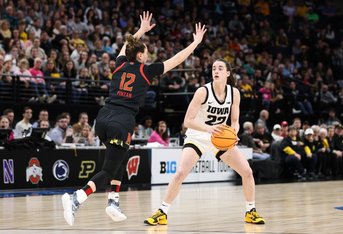 Mar 4, 2023; Minneapolis, MINN, USA; Iowa Hawkeyes guard Caitlin Clark (22) looks to pass while Maryland Terrapins guard Elisa Pinzan (12) defends during the first half at Target Center.