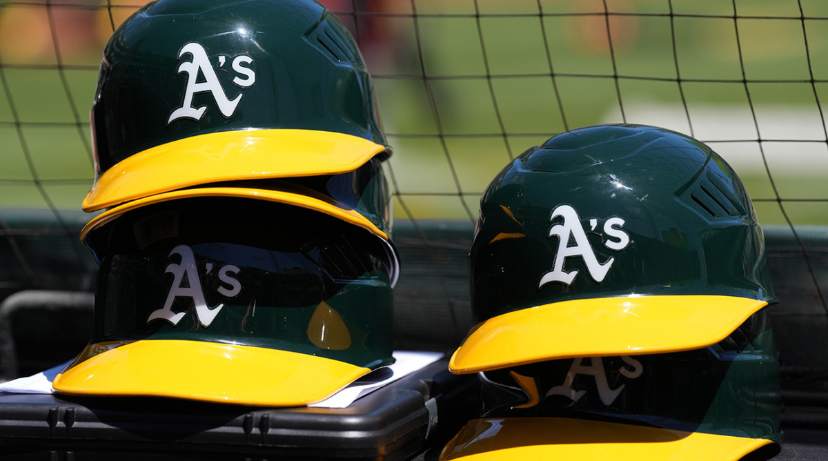 Oakland Athletics helmets are stacked near the field before the game against the Texas Rangers at RingCentral Coliseum.