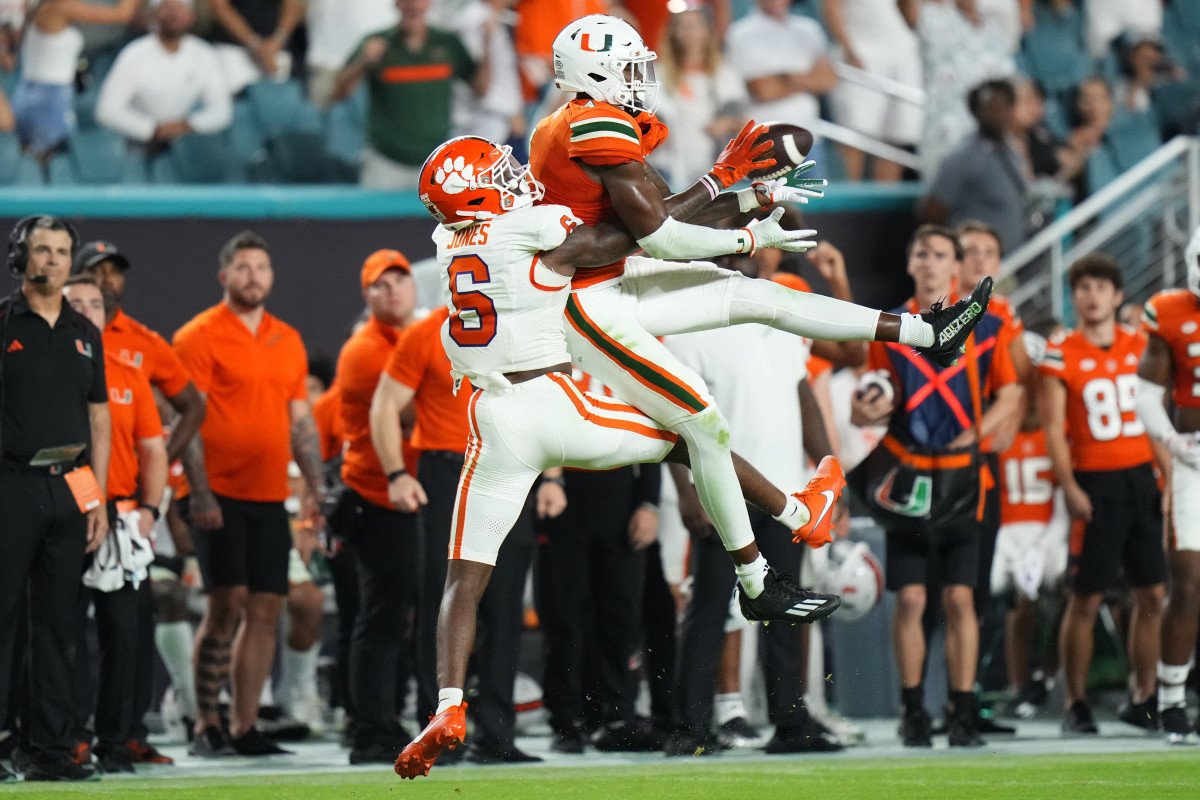 Oct 21, 2023; Miami Gardens, Florida, USA; Miami Hurricanes wide receiver Colbie Young (4) makes a catch against Clemson Tigers cornerback Sheridan Jones (6) during the fourth quarter at Hard Rock Stadium. (Rich Storry / USA TODAY Sports).