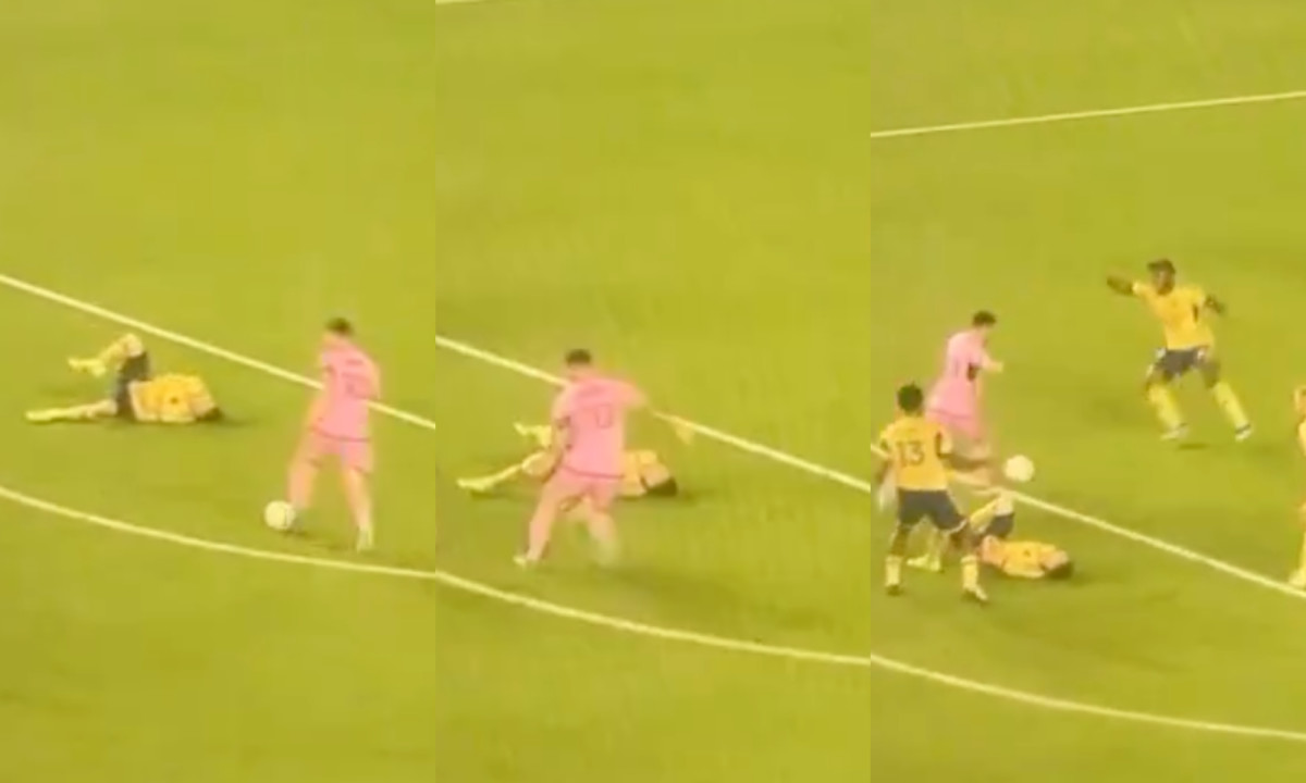 Inter Miami captain Lionel Messi pictured (in pink) dribbling past Real Salt Lake defender Andrew Brody while he is lying on the ground during the opening game of the 2024 MLS season