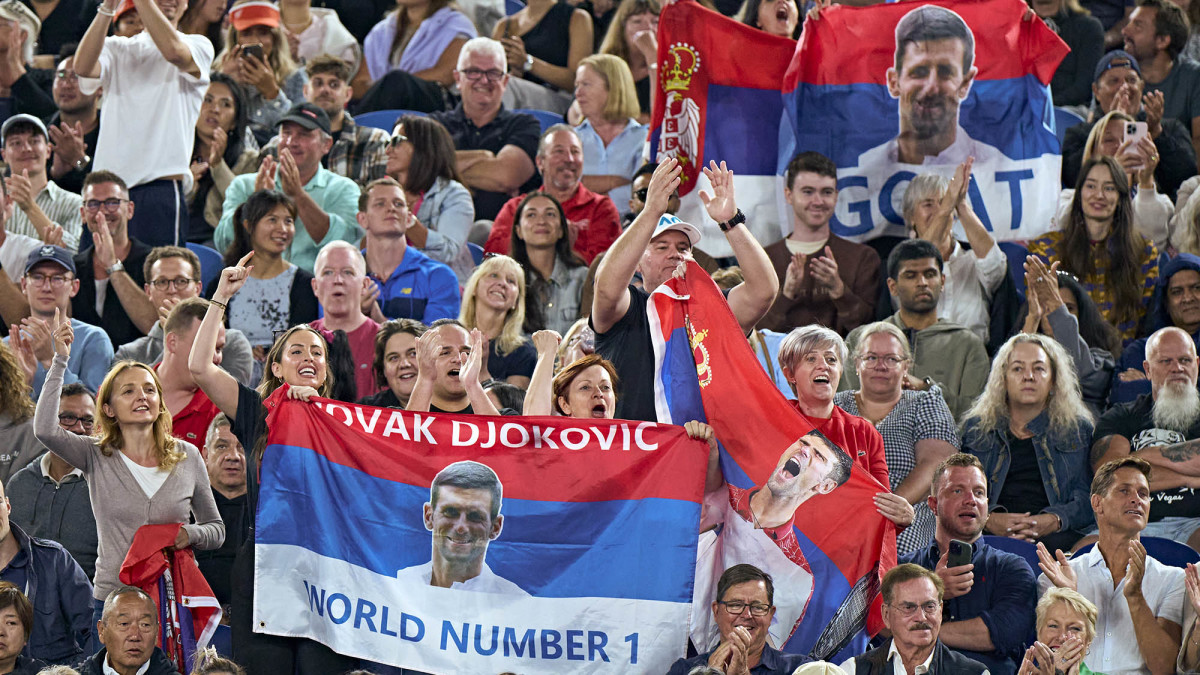 Fans supports Novak Djokovic with Serbian flags donning his face.