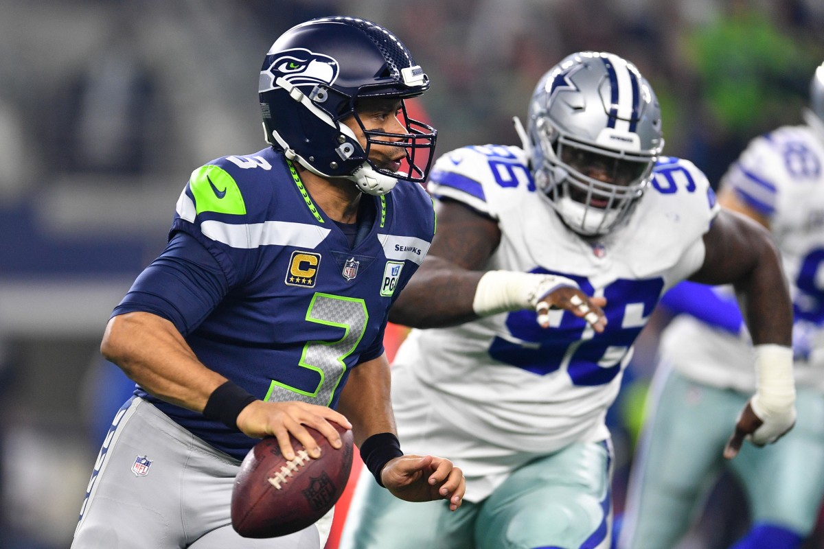 Seattle Seahawks quarterback Russell Wilson (3) against the Dallas Cowboys in the first quarter in a NFC Wild Card playoff football game at AT&T Stadium.