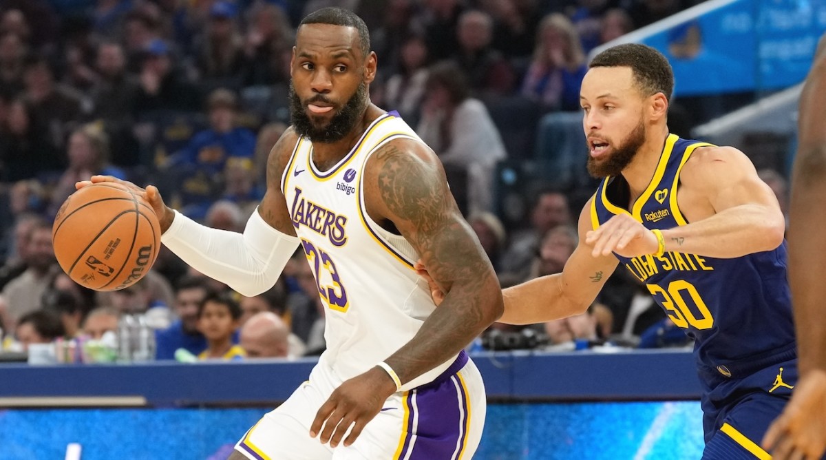 Los Angeles Lakers forward LeBron James (23) dribbles against Golden State Warriors guard Stephen Curry (30) during the first quarter at Chase Center in San Francisco, California, on Jan. 27, 2024.