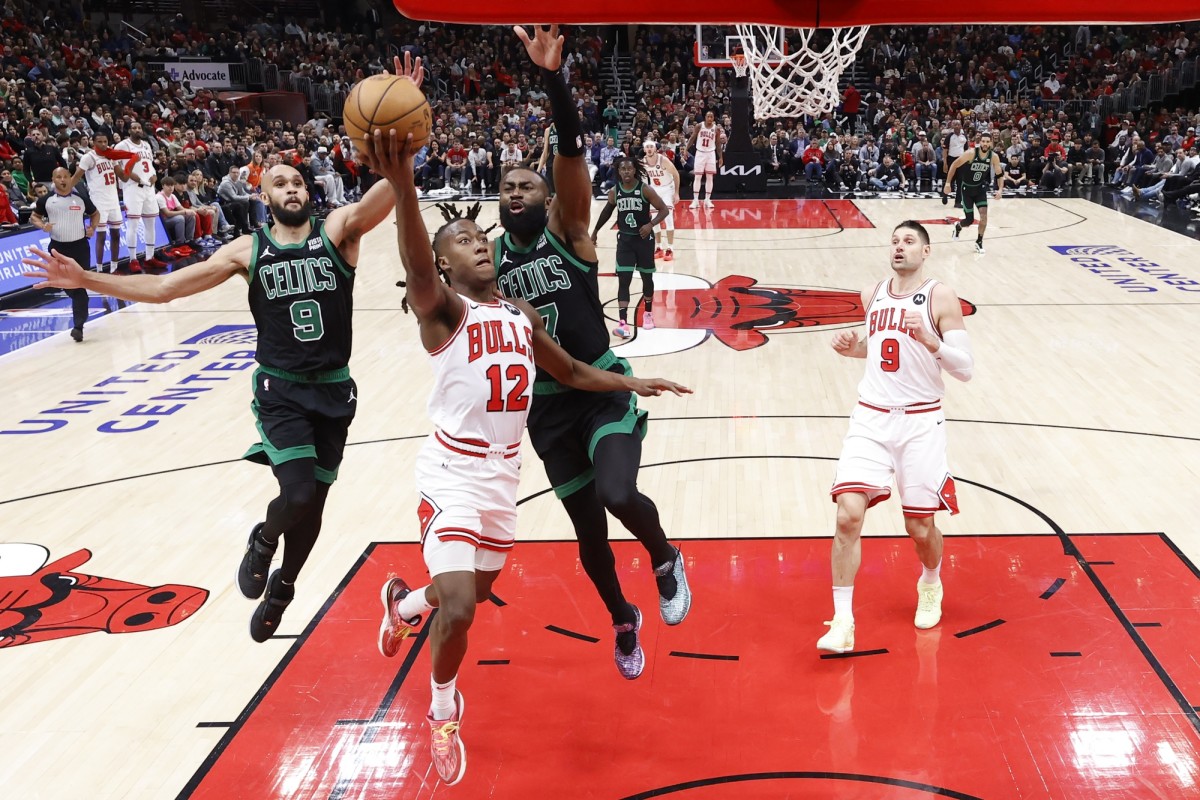  Chicago Bulls guard Ayo Dosunmu (12) goes to the basket against Boston Celtics guard Jaylen Brown (7) during the second half at United Center.