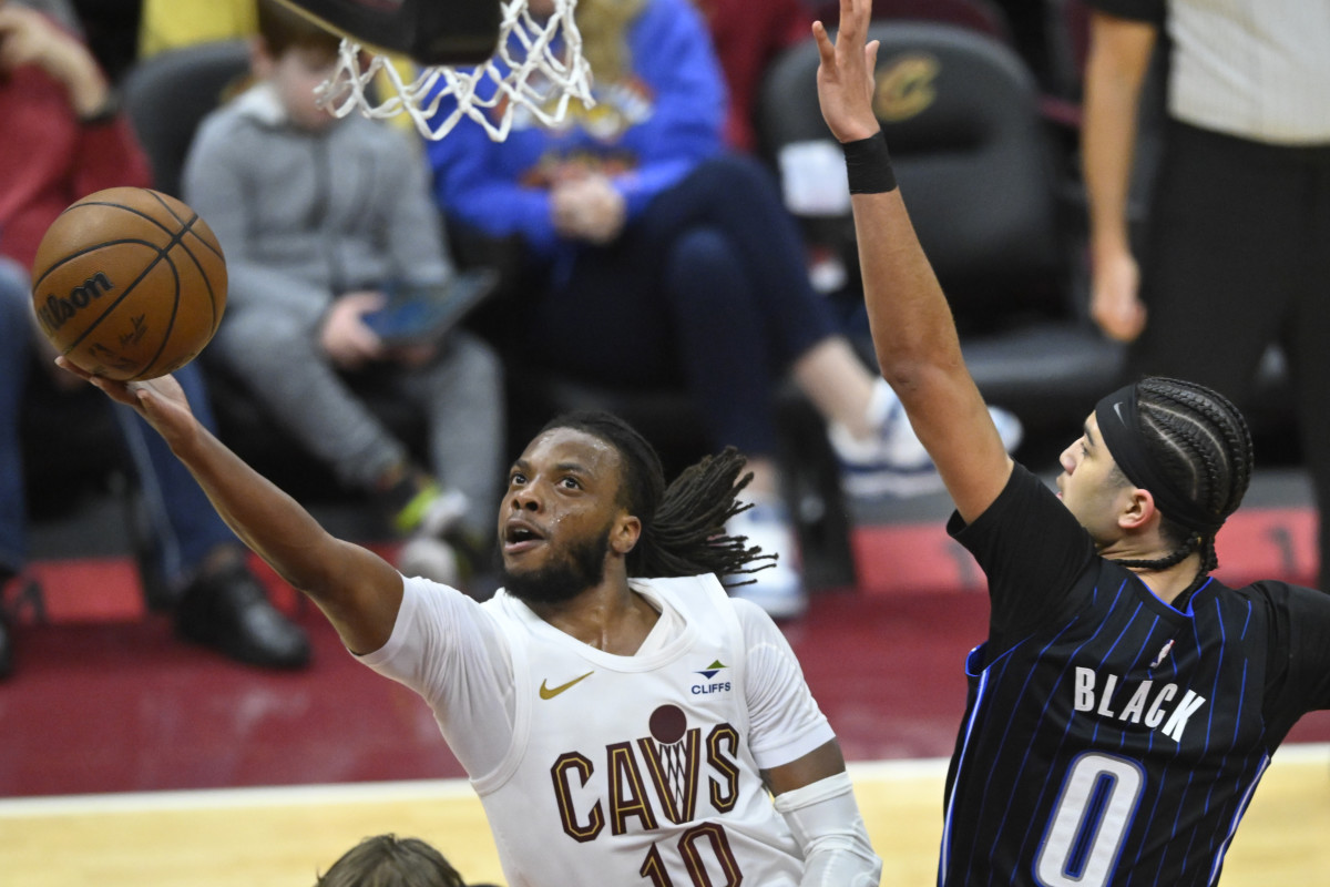 Feb 22, 2024; Cleveland, Ohio, USA; Cleveland Cavaliers guard Darius Garland (10) lays up a shot beside Orlando Magic guard Anthony Black (0) in the third quarter at Rocket Mortgage FieldHouse.