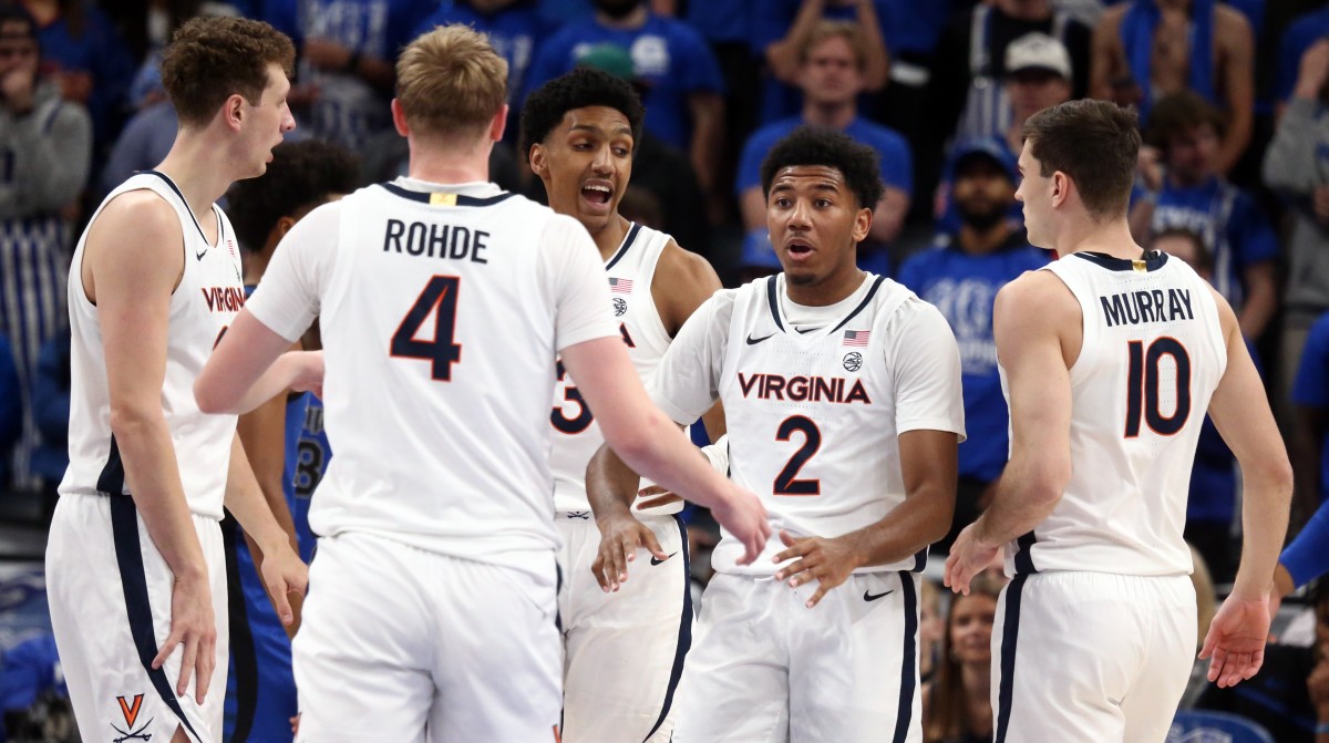Virginia Cavaliers forward Jake Groves (34), guard Andrew Rohde (4), guard/forward Leon Bond III (35), guard Reece Beekman (2) and guard Taine Murray (10) huddle during the first half against the Memphis Tigers at FedExForum.
