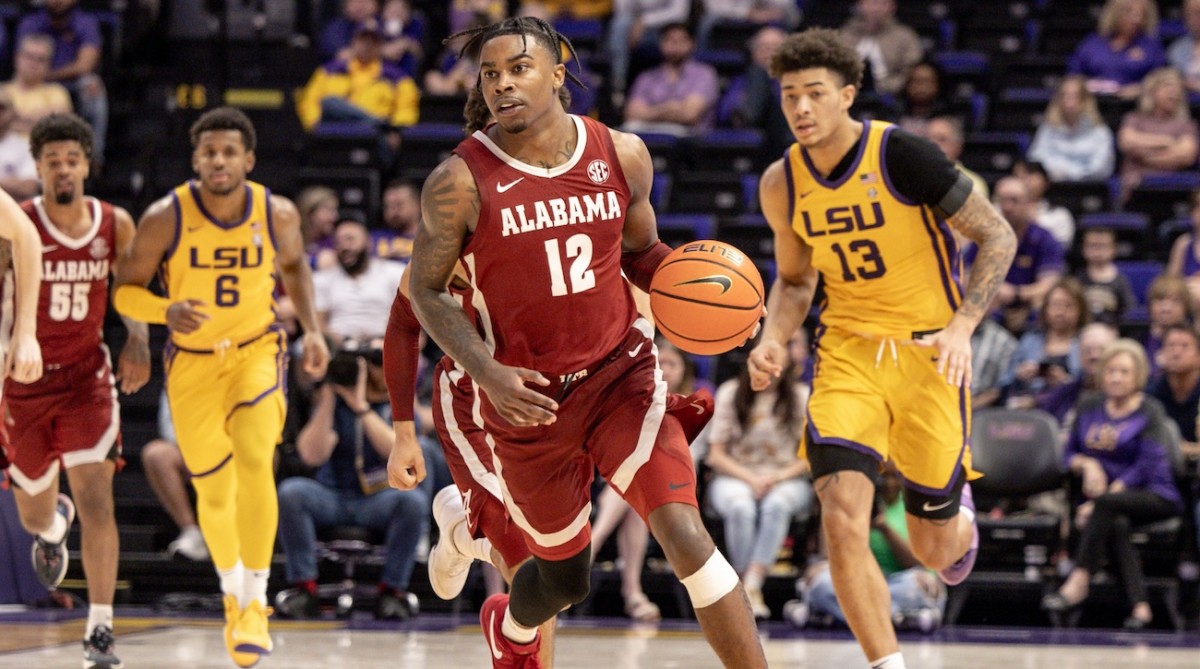 Alabama Crimson Tide guard Latrell Wrightsell Jr. (12) brings the ball up court against LSU Tigers forward Jalen Reed (13) during the second half at Pete Maravich Assembly Center in Baton Rouge, Louisiana, on Feb. 10, 2024.