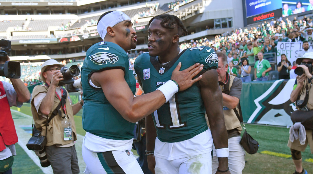 Philadelphia Eagles stars Jalen Hurts and A.J. Brown leave the field after a game against the Washington Commanders.