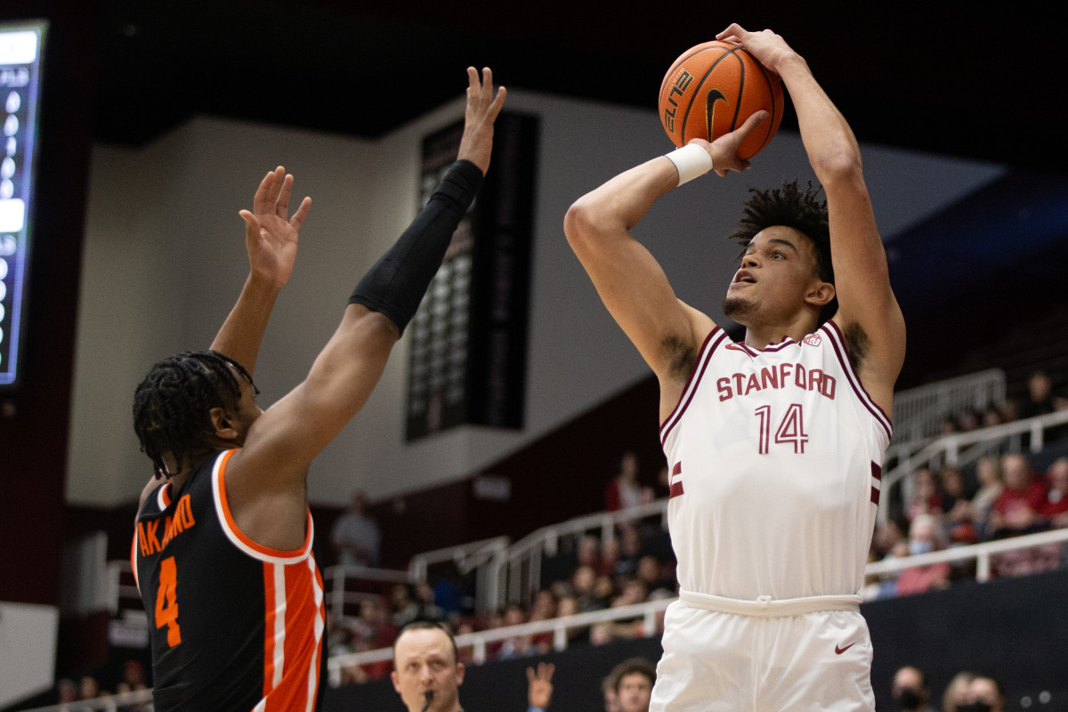 Feb 24, 2024; Stanford, California, USA; Stanford Cardinal forward Spencer Jones (14) attempts a three point basket over Oregon State Beavers guard Dexter Akanno (4) during the first half at Maples Pavilion. Mandatory Credit: D. Ross Cameron-USA TODAY Sports