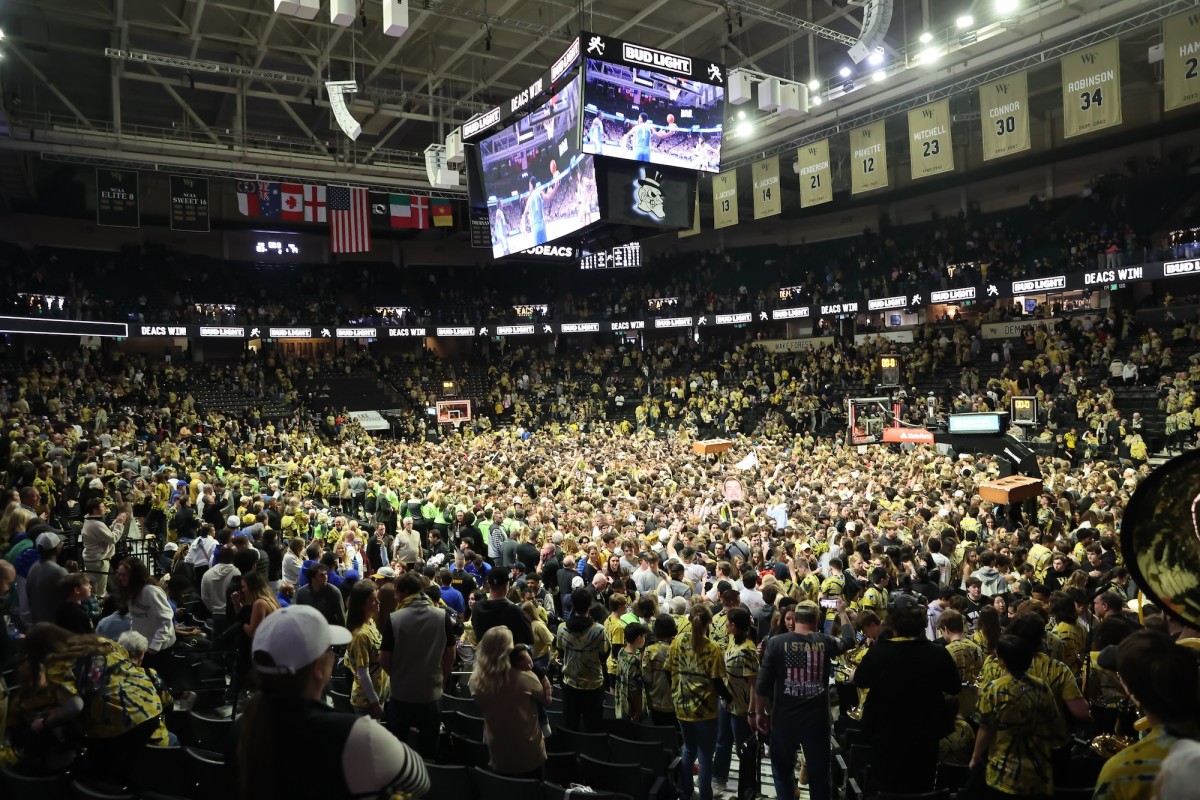 Wake Forest Demon Deacons students storm the court after Wake Forest beat the Duke Blue Devils at Lawrence Joel Veterans Memorial Coliseum in Winston-Salem, North Carolina, on Feb. 24, 2024.