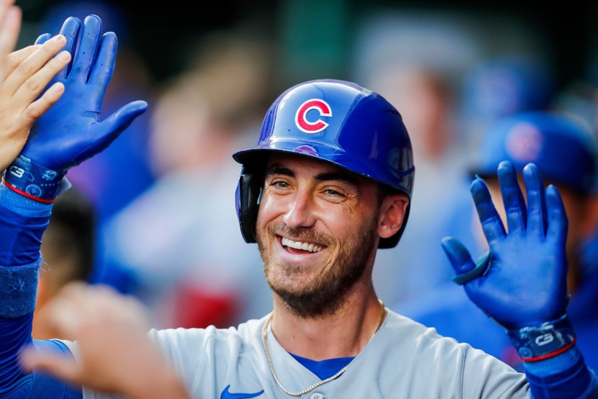 Sep 1, 2023; Cincinnati, Ohio, USA; Chicago Cubs first baseman Cody Bellinger (24) high fives teammates after hitting a solo home run in the third inning against the Cincinnati Reds at Great American Ball Park.