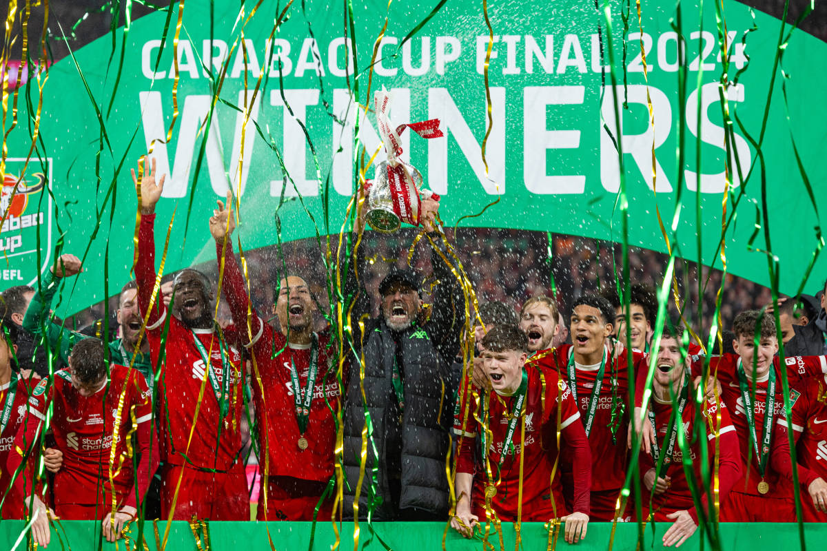 Liverpool manager Jurgen Klopp pictured (center) lifting the EFL Cup trophy following his team's 1-0 win over Chelsea in the 2024 final