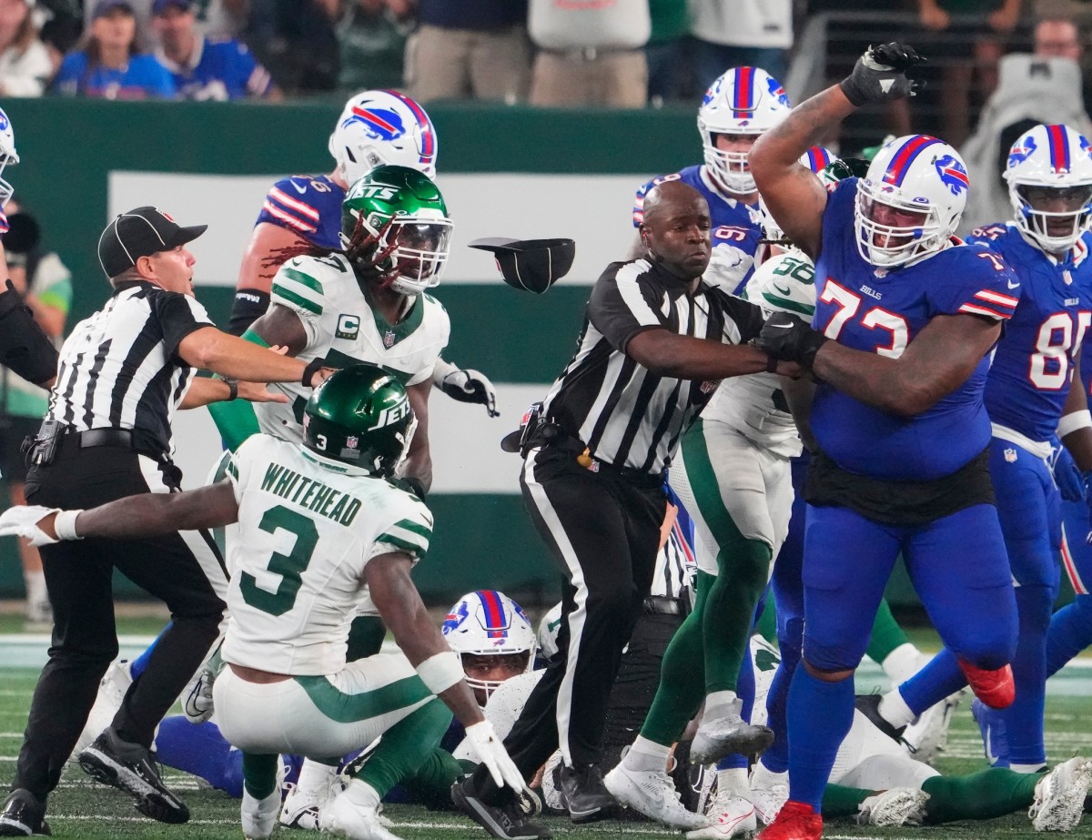 Sep 11, 2023; East Rutherford, New Jersey, USA; New York Jets safety Jordan Whitehead (3) gets pushed down by Buffalo Bills offensive tackle Dion Dawkins (73) in a scuffle following a Jets recovery of a Bills fumble in the second half at MetLife Stadium.