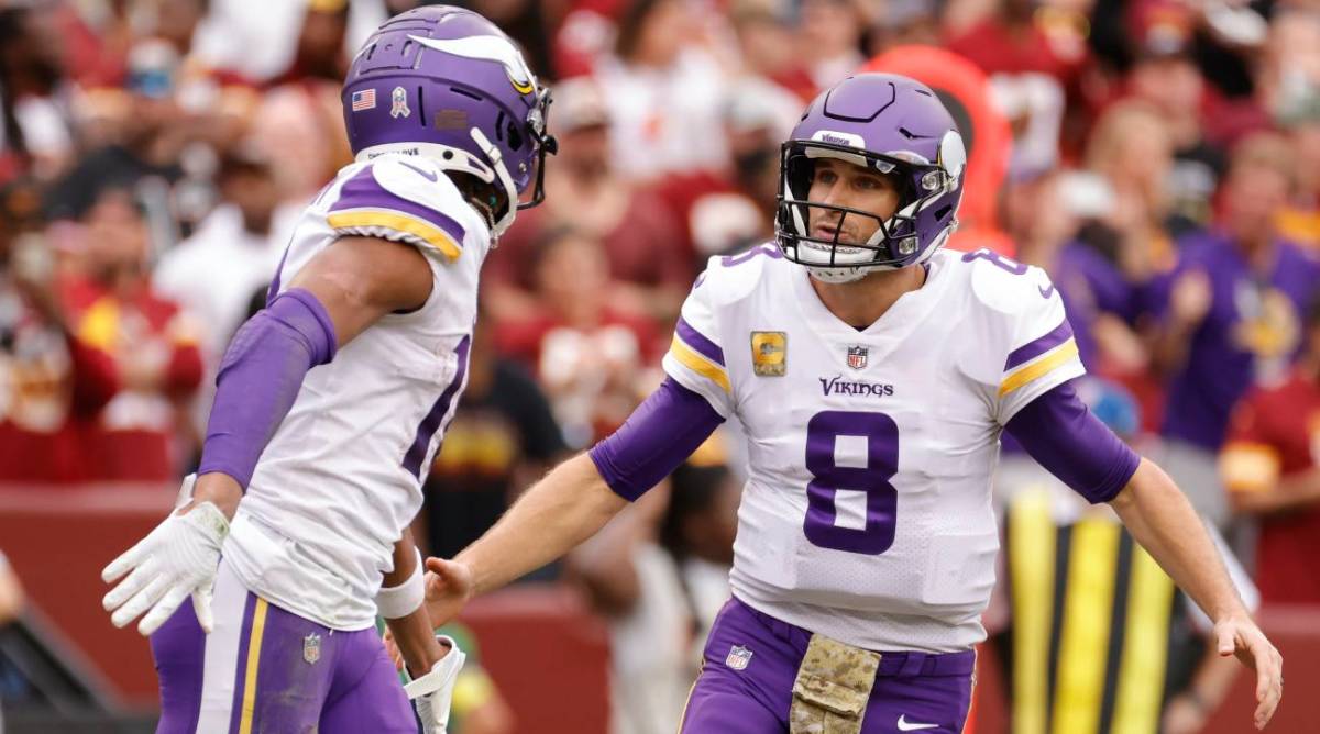 Kirk Cousins celebrates a touchdown with Justin Jefferson.