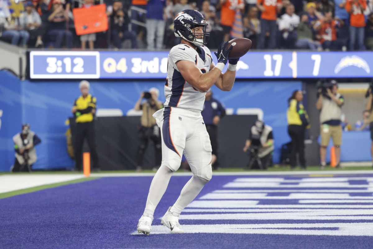 Dec 10, 2023; Inglewood, California, USA; Denver Broncos tight end Adam Trautman (82) scores a touchdown during the second half in a game against the Los Angeles Chargers at SoFi Stadium.