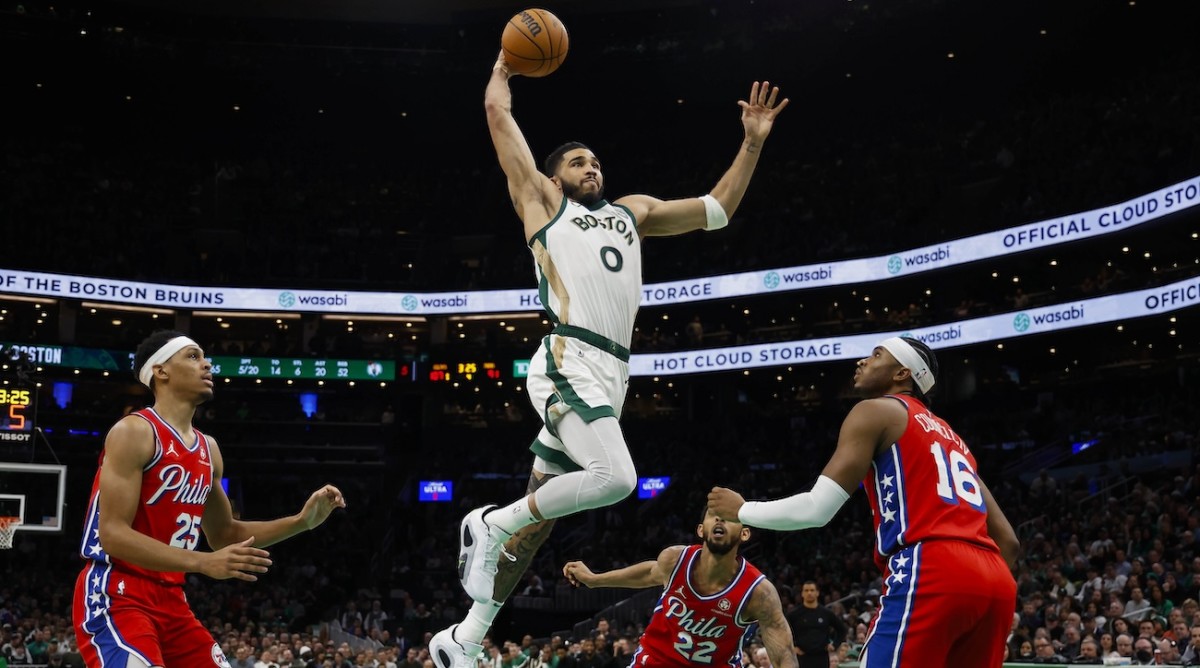 Boston Celtics forward Jayson Tatum (0) goes in for a dunk as Philadelphia 76ers forward Darius Bazley (25) and guard Ricky Council IV (16) look on during the second half at TD Garden in Boston, Massachusetts, on Feb. 27, 2024.