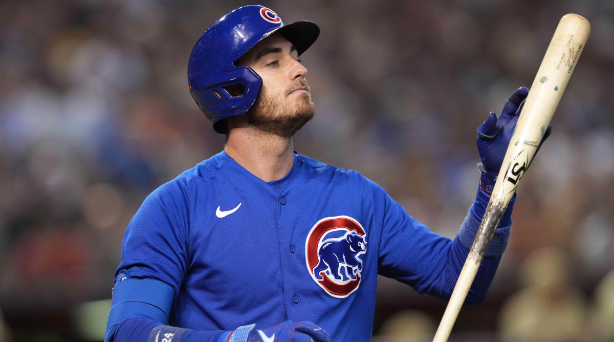 Cubs outfielder Cody Bellinger looks at his bat after striking out