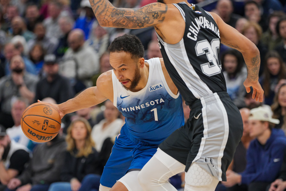 Minnesota Timberwolves forward Kyle Anderson (1) dribbles against the San Antonio Spurs forward Julian Champagnie (30) in the first quarter at Target Center in Minneapolis on Feb. 27, 2024.