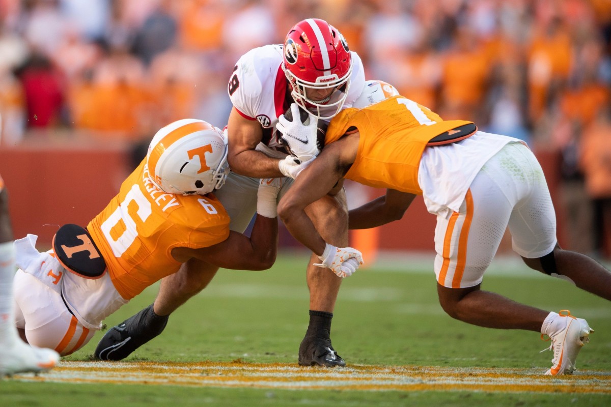 Georgia tight end Brock Bowers (19) is tackled by Tennessee linebacker Aaron Beasley (6) during a football game between Tennessee and Georgia at Neyland Stadium in Knoxville, Tenn., on Saturday, Nov. 18, 2023.