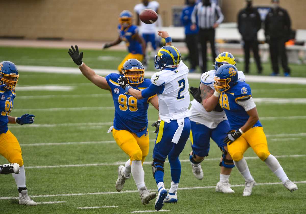 South Dakota State's Caleb Sanders reaches toward Delaware quarterback Nolan Henderson in the FCS semifinals on Saturday, May 8, 2021, at Dana J. Dykhouse Stadium in Brookings.