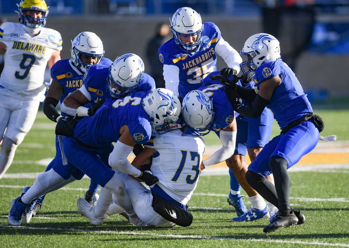 South Dakota State players swarm Delaware's Brett Buckman to tackle him in an FCS playoff game on December 3, 2022, at Dana J. Dykhouse Stadium in Brookings.