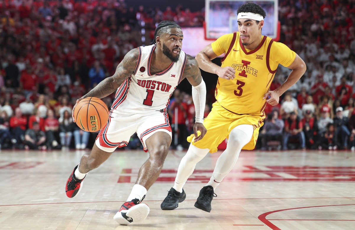 Feb 19, 2024; Houston, Texas, USA; Houston Cougars guard Jamal Shead (1) drives with the ball as Iowa State Cyclones guard Tamin Lipsey (3) defends during the second half at Fertitta Center. 