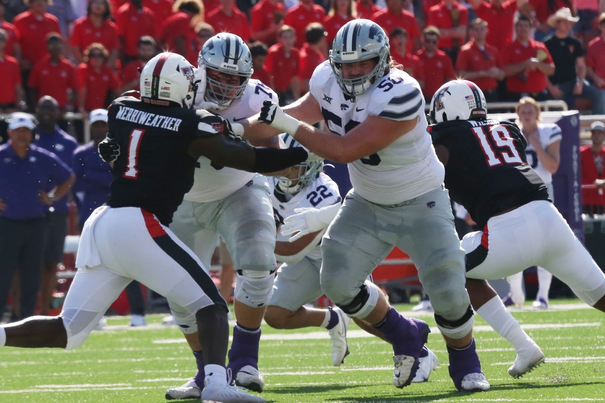 Oct 23, 2021; Lubbock, Texas, USA; Kansas State Wildcats offensive tackle Cooper Beebe (50) blocks Texas Tech Red Raiders defensive linebacker Krishon Merriweather (1) in the first half at Jones AT&T Stadium.