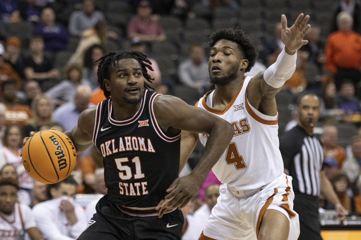 Oklahoma State Cowboys guard John-Michael Wright (51) handles the ball while defended by Texas Longhorns guard Tyrese Hunter (4) in the first half at T-Mobile Center.