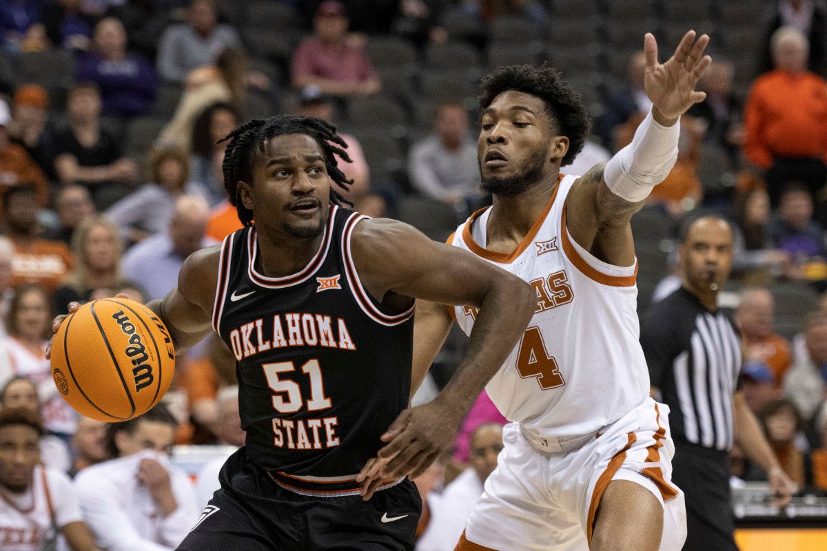 Oklahoma State Cowboys guard John-Michael Wright (51) handles the ball while defended by Texas Longhorns guard Tyrese Hunter (4) in the first half at T-Mobile Center.