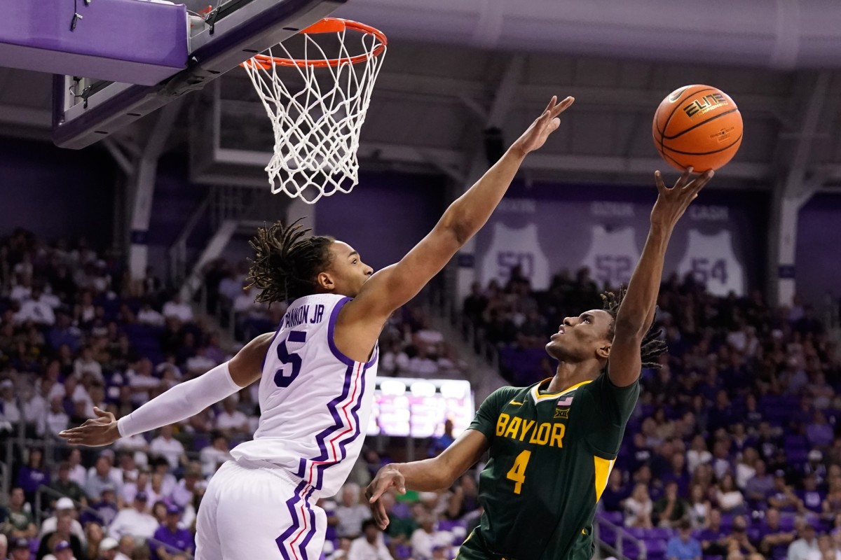 Baylor Bears guard Ja'Kobe Walter (4) shoots over TCU Horned Frogs forward Chuck O'Bannon Jr. (5) during the second half at Ed and Rae Schollmaier Arena.