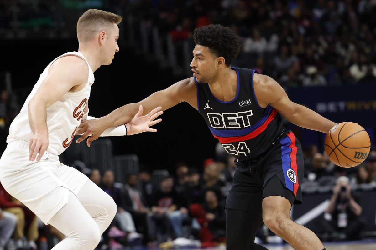 Mar 1, 2024; Detroit, Michigan, USA; Detroit Pistons guard Quentin Grimes (24) dribbles against Cleveland Cavaliers guard Sam Merrill (5) in the first half at Little Caesars Arena.