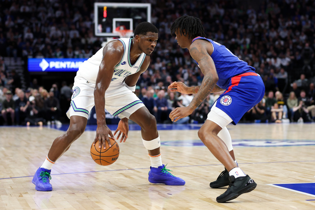 Minnesota Timberwolves guard Anthony Edwards (5) dribbles as LA Clippers guard Bones Hyland (5) defends during the first half at Target Center in Minneapolis on March 3, 2024.