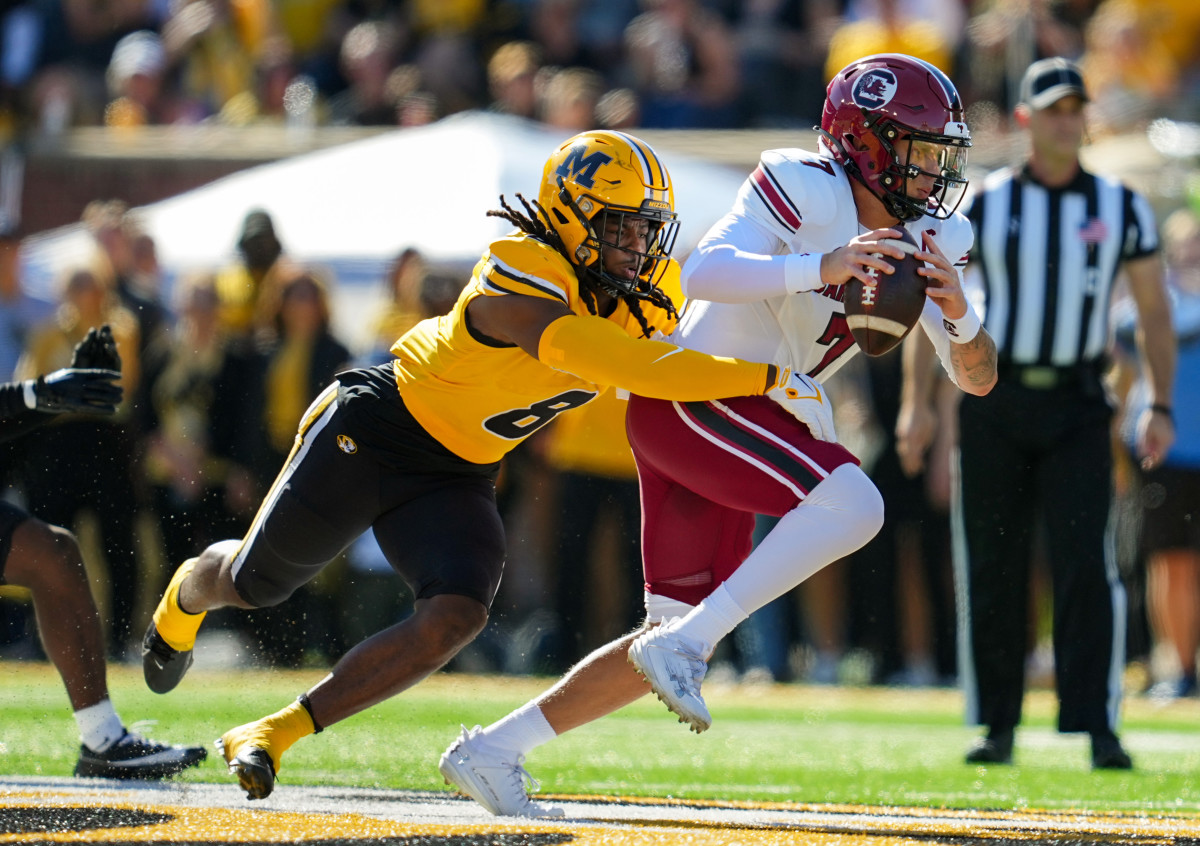 Oct 21, 2023; Columbia, Missouri, USA; South Carolina Gamecocks quarterback Spencer Rattler (7) is tackled by Missouri Tigers linebacker Ty'Ron Hopper (8) during the first half at Faurot Field at Memorial Stadium. Mandatory Credit: Jay Biggerstaff-USA TODAY Sports