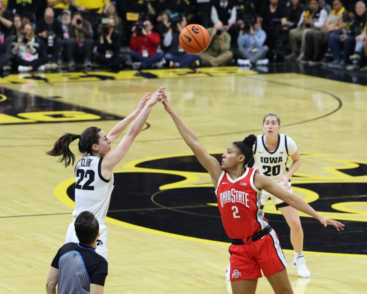 Mar 3, 2024; Iowa City, Iowa, USA; Iowa Hawkeyes guard Caitlin Clark (22) shoots over the hands of Ohio State Buckeyes guard Taylor Thierry (2) during the first half at Carver-Hawkeye Arena.