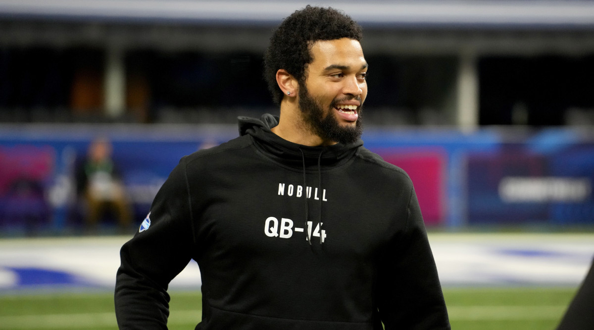 Caleb Williams looks to the side smiling at the combine