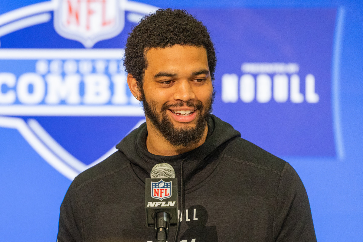 Caleb Williams talks into a microphone at the combine