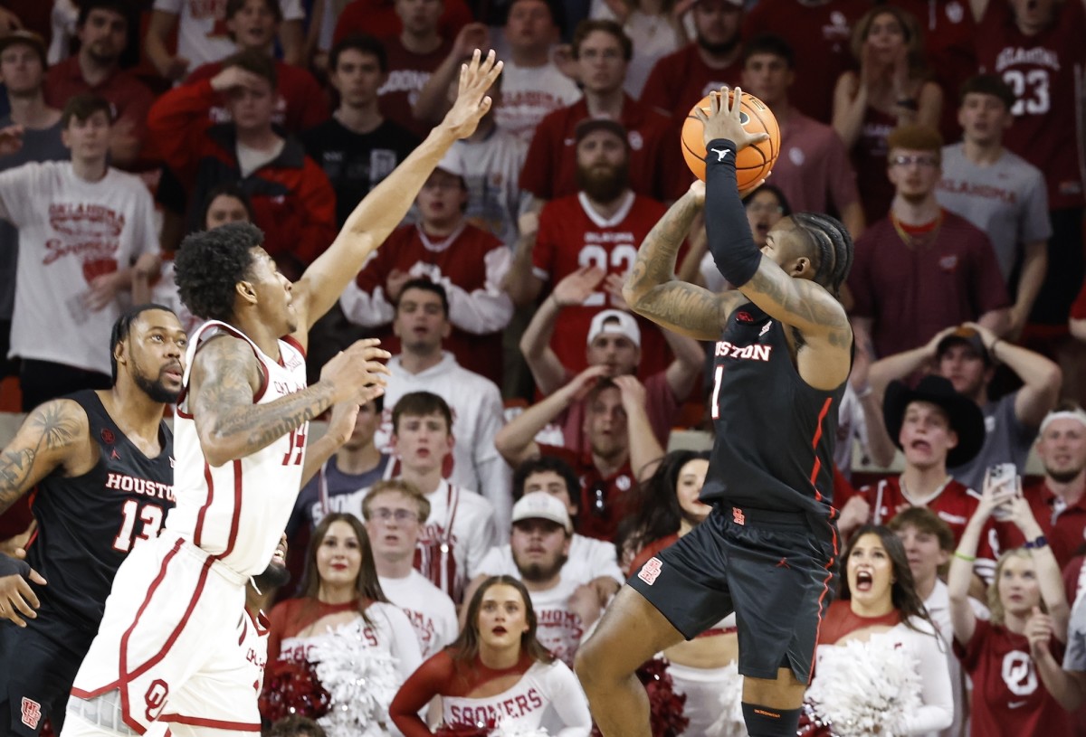 Houston Cougars guard Jamal Shead (1) shoots as Oklahoma Sooners forward Jalon Moore (14) defends during the second half at Lloyd Noble Center in Norman, Oklahoma, on March 2, 2024.