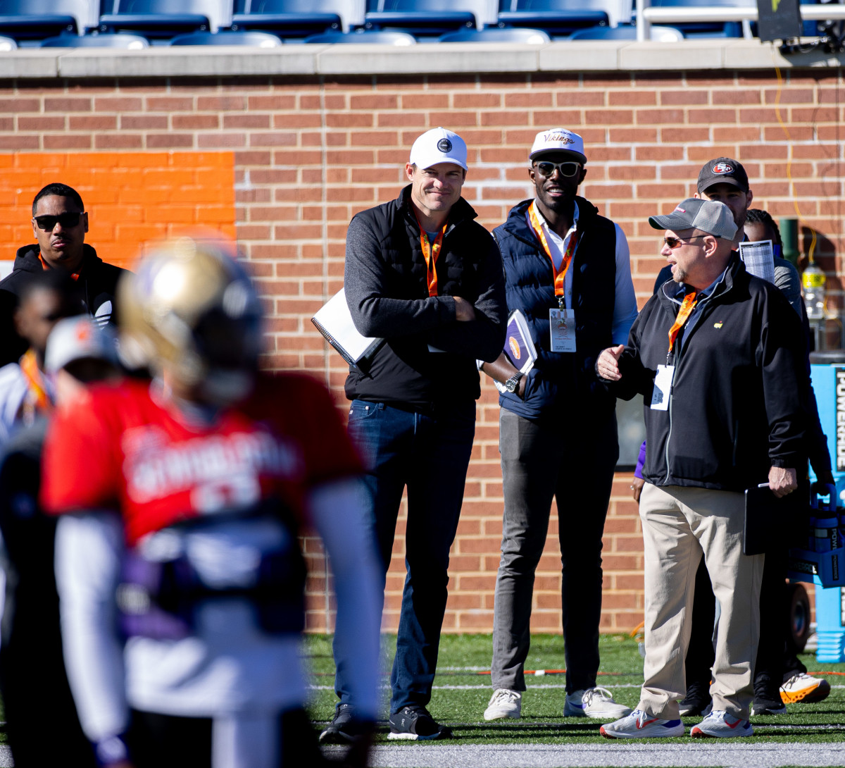 Kevin O'Connell and Kwesi Adofo-Mensah watch quarterback Michael Penix Jr. at the Senior Bowl in Mobile, Alabama.