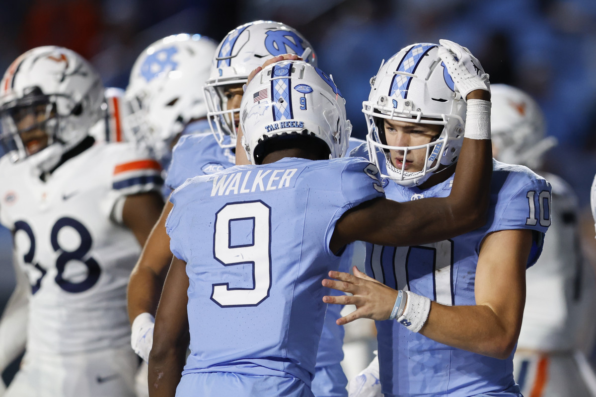 Drake Maye leans in to hug Devontez Walker