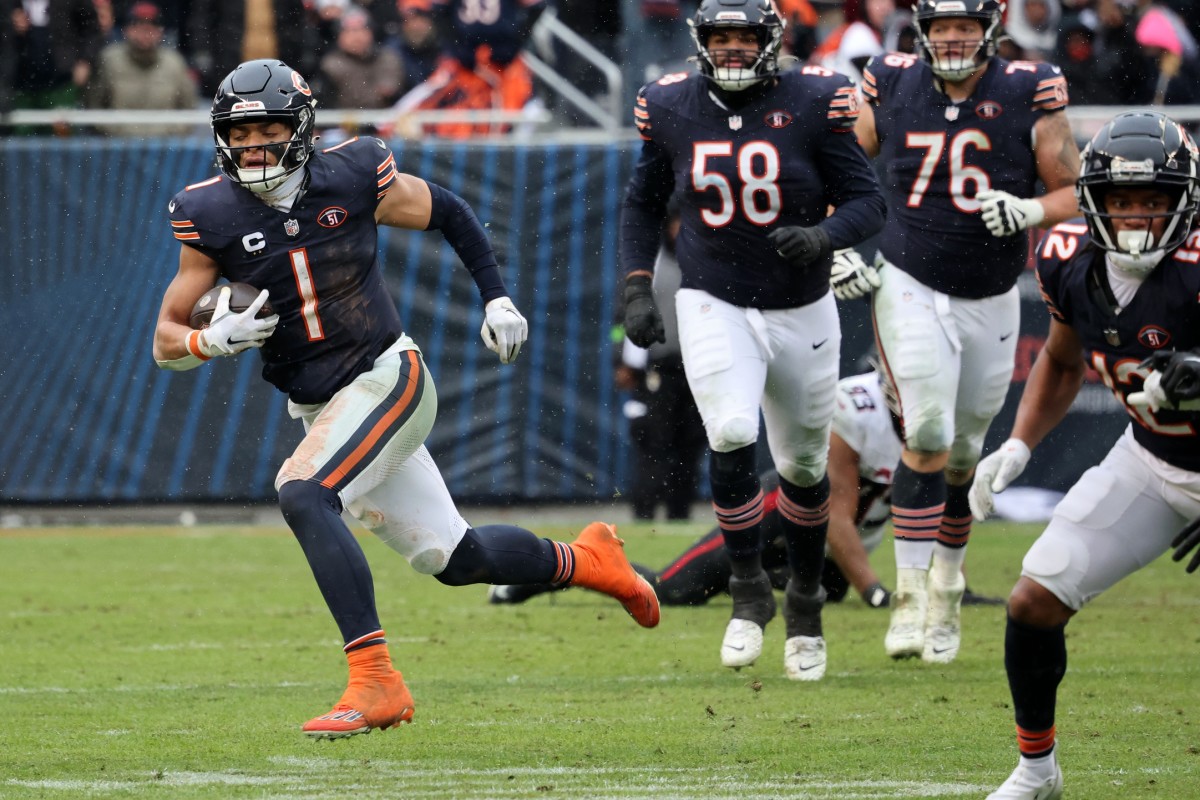 Chicago Bears quarterback Justin Fields (1) rushes the ball against the Atlanta Falcons. Mandatory Credit: Mike Dinovo-USA TODAY