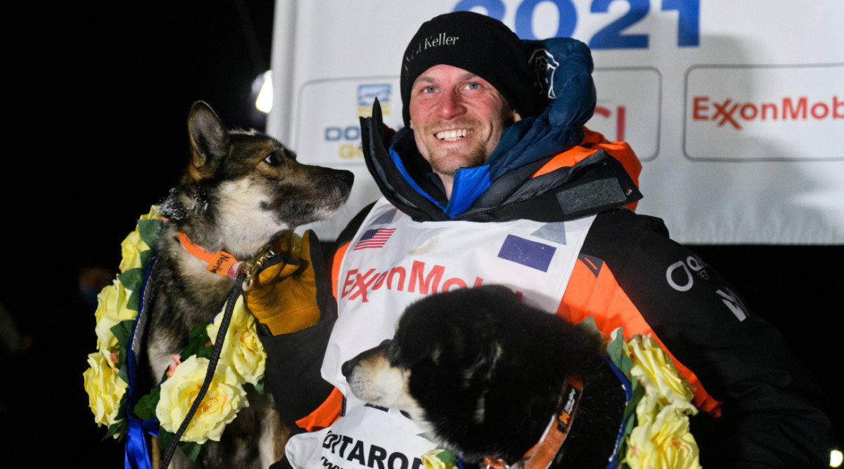 Iditarod musher Dallas Seavey poses with his dogs North and Gamble.