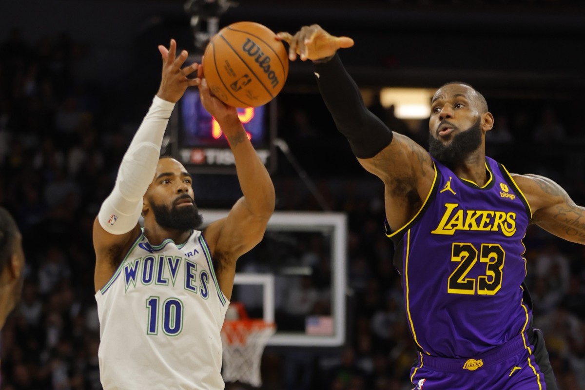 Dec 30, 2023; Minneapolis, Minnesota, USA; Los Angeles Lakers forward LeBron James (23) knocks the ball as Minnesota Timberwolves guard Mike Conley (10) shoots in the fourth quarter at Target Center.