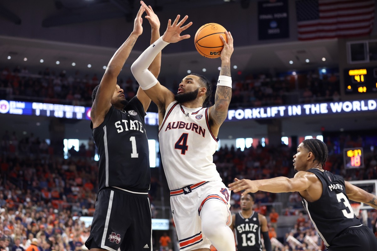 Auburn Tigers forward Johni Broome (4) takes a shot against Mississippi State Bulldogs forward Tolu Smith (1) during the second half at Neville Arena in Auburn, Alabama, March 2, 2024.