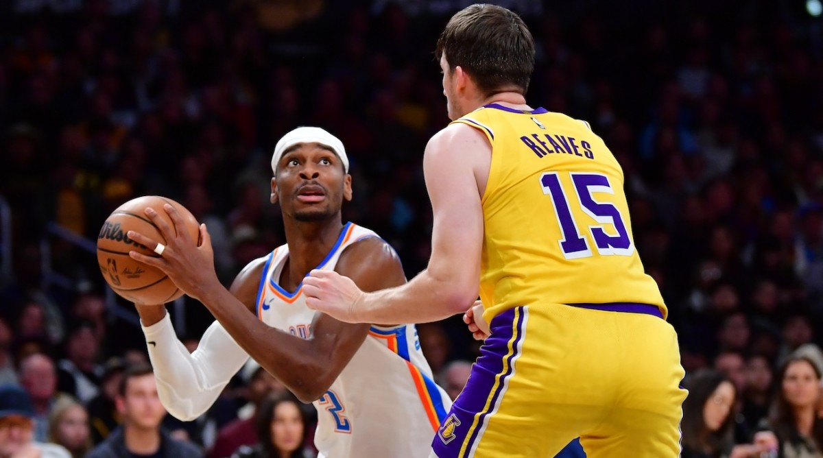 Oklahoma City Thunder guard Shai Gilgeous-Alexander (2) controls the ball against Los Angeles Lakers guard Austin Reaves (15) during the second half at Crypto.com Arena in Los Angeles on March 4, 2024.